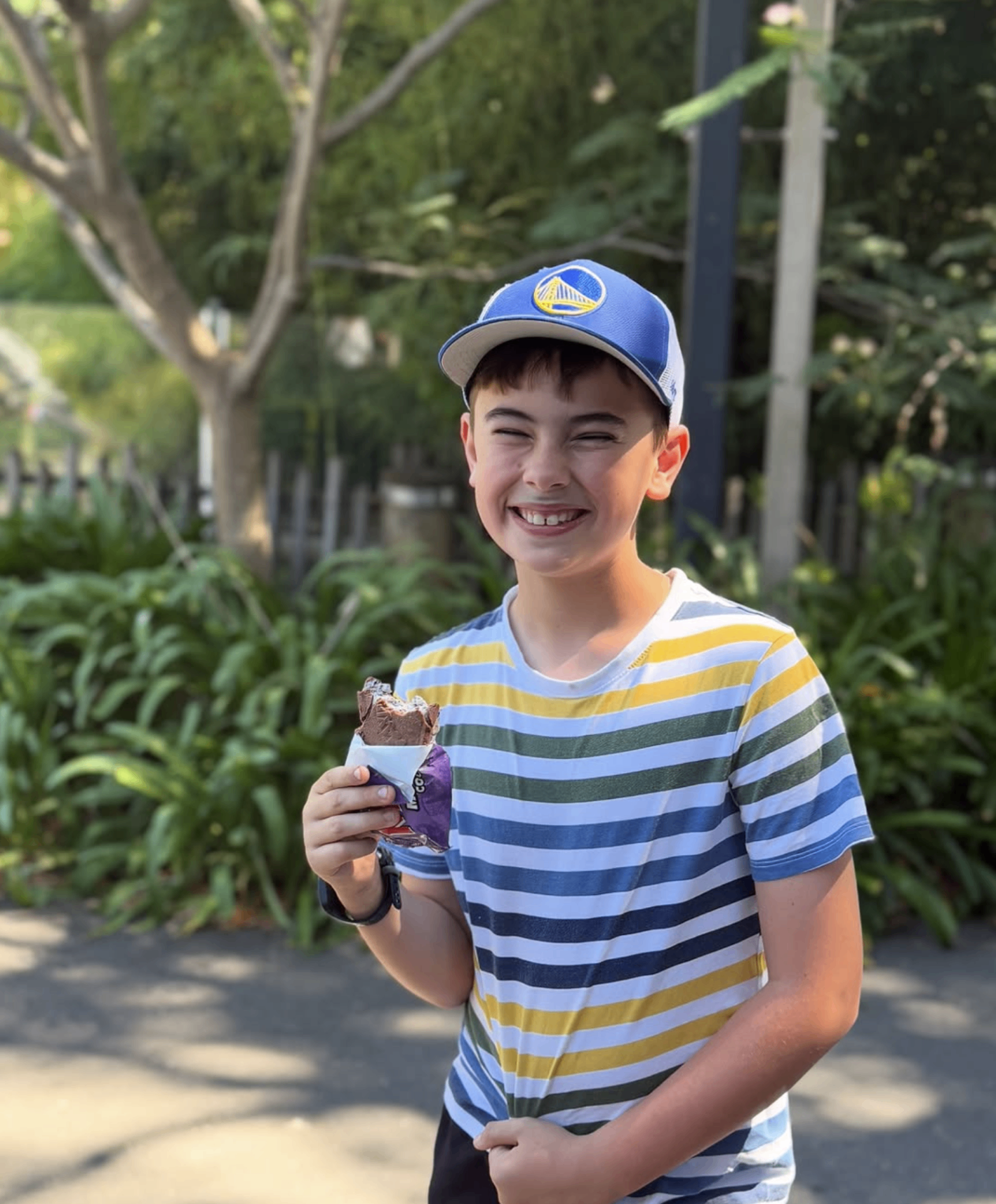 Older child enjoying an ice cream in a leafy Adelaide park during an outdoor adventure